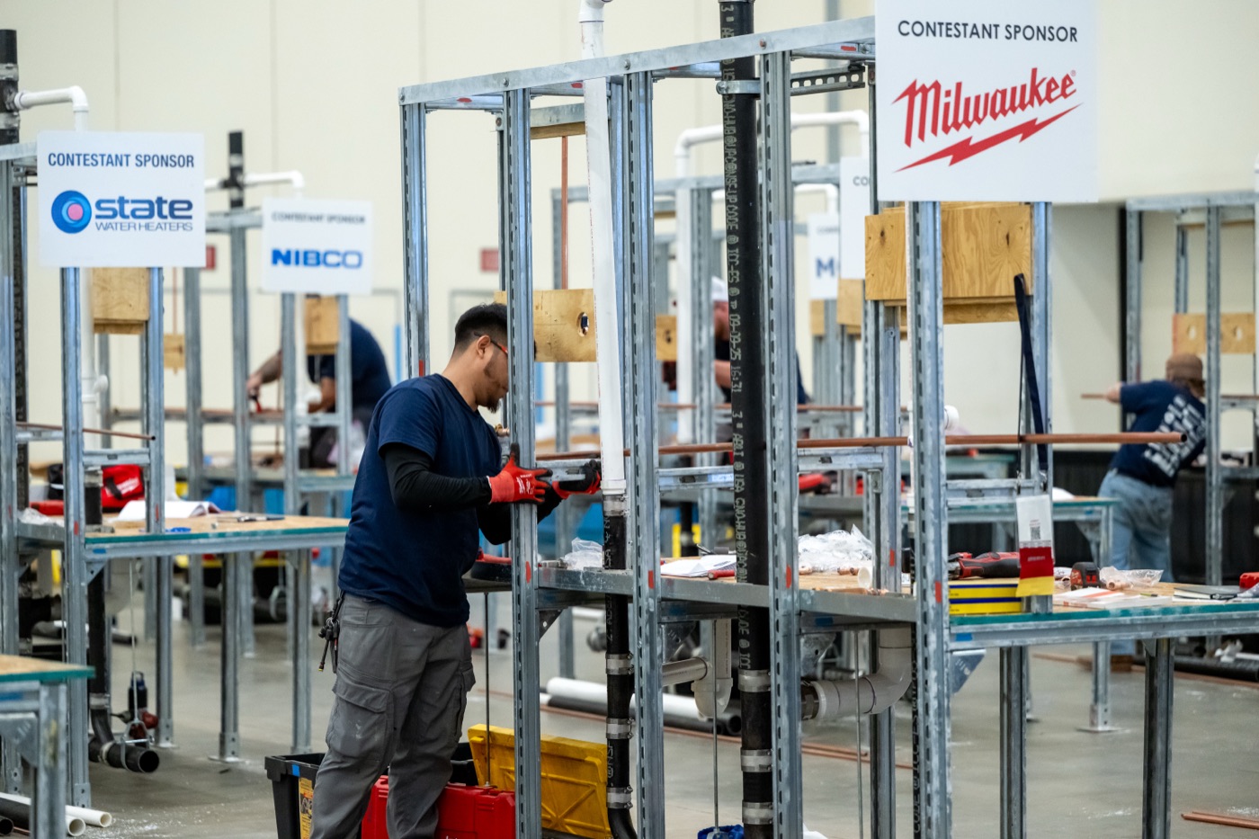 National Plumbing Apprentice Contest — contestant building a rough-in at a Milwaukee Tool sponsored station